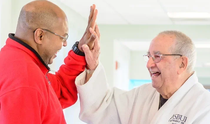 Staff and resident sharing a joyful moment indoors