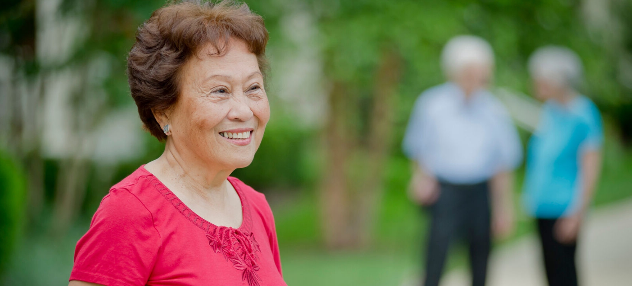 Senior woman smiling in a garden