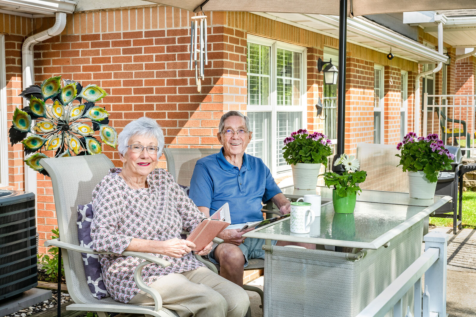 Two residents enjoying the patio at an assisted living facility