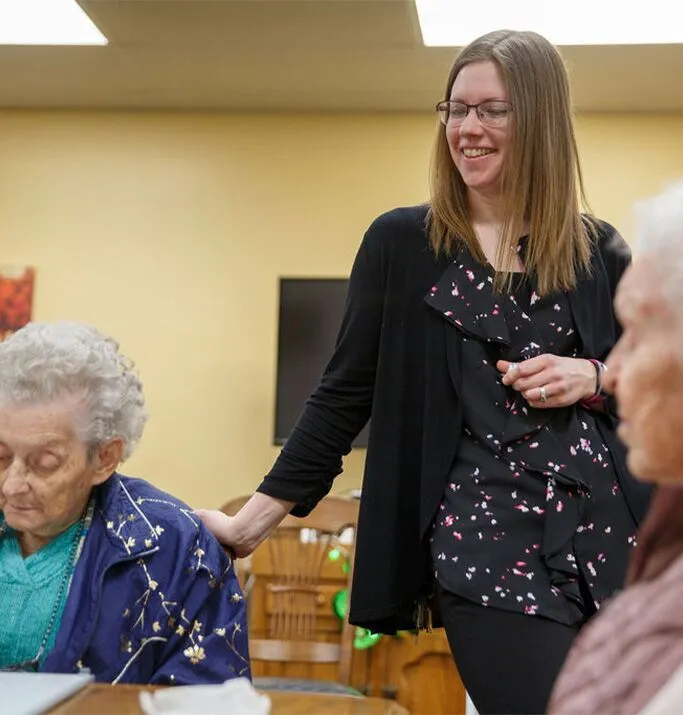 Staff member interacting with residents in a common area