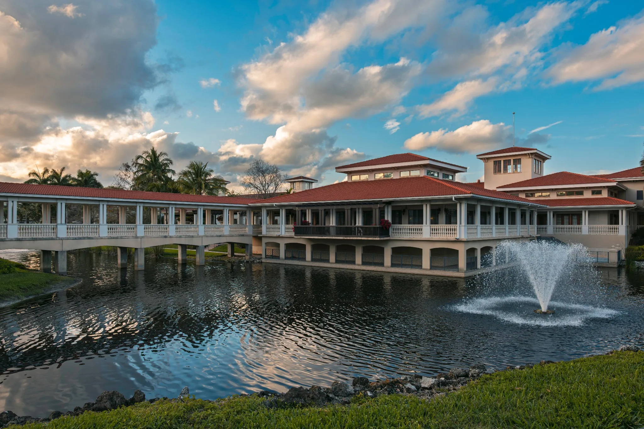 Exterior view of a senior living facility by a pond