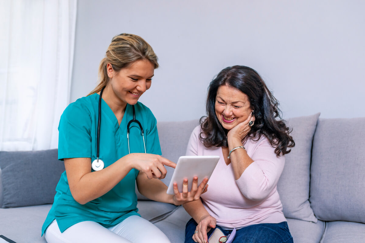 Staff member showing a tablet to a resident