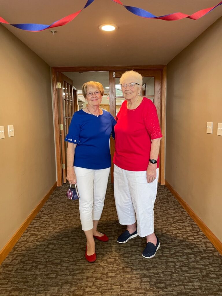 Two residents celebrating in the hallway
