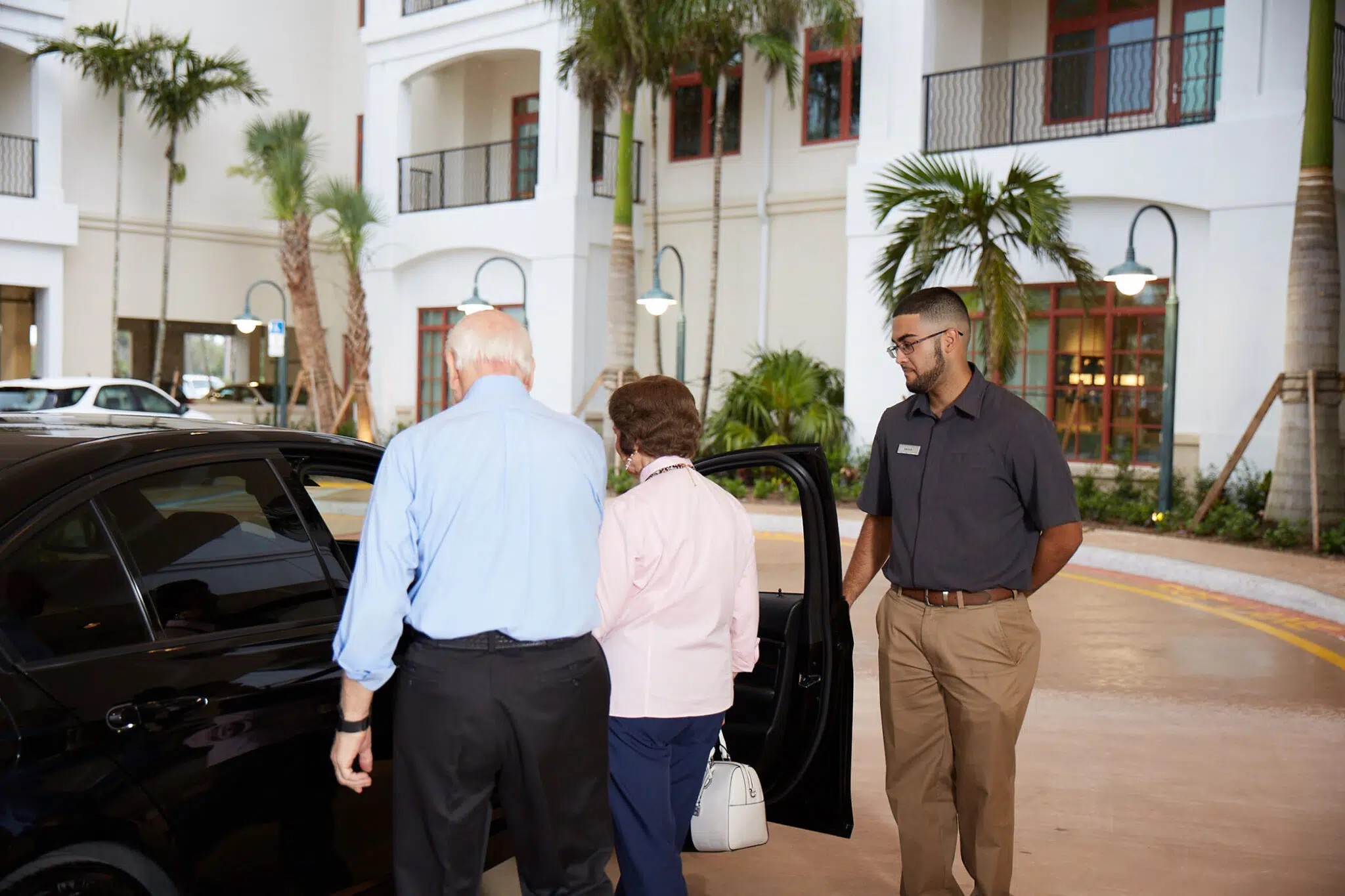 Staff assisting residents at the entrance of the facility