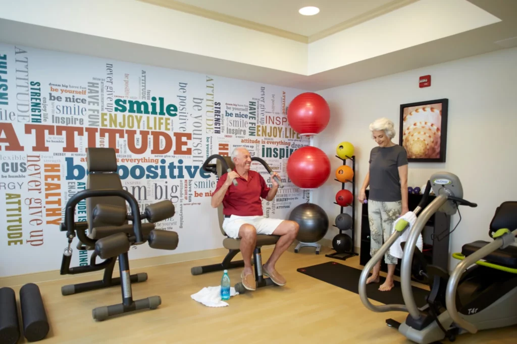 Residents exercising with fitness equipment in a gym