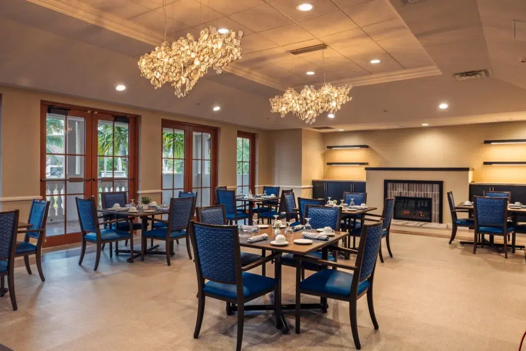 Bright dining room with blue chairs and elegant lighting