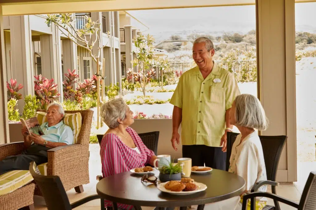 Staff interacting with residents on a patio