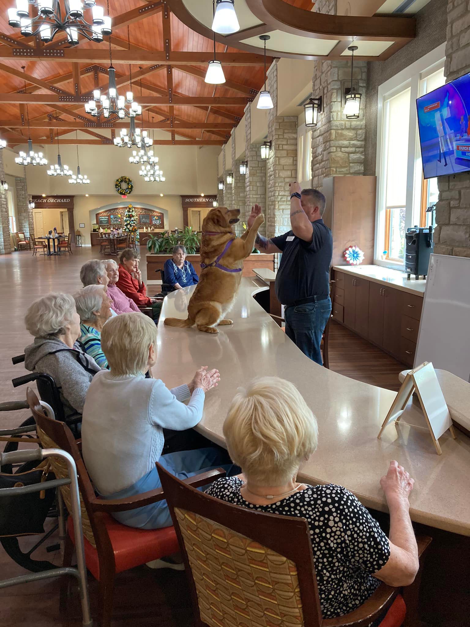 Residents enjoying an activity with a pet dog.