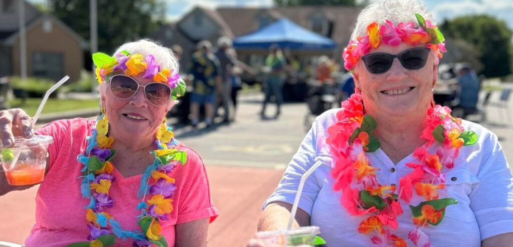 Two residents enjoying a colorful outdoor celebration.