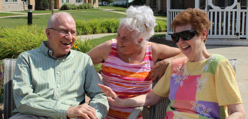 Three residents enjoying a sunny day outdoors