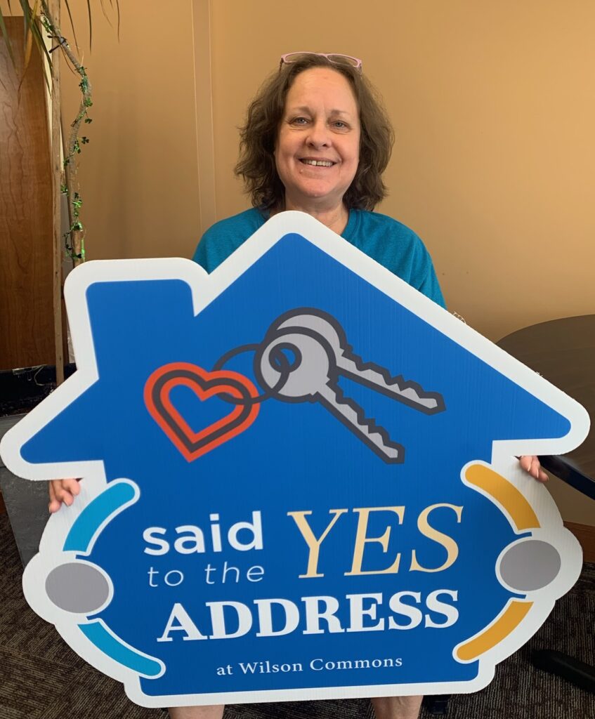 Person holding a promotional sign in a common area
