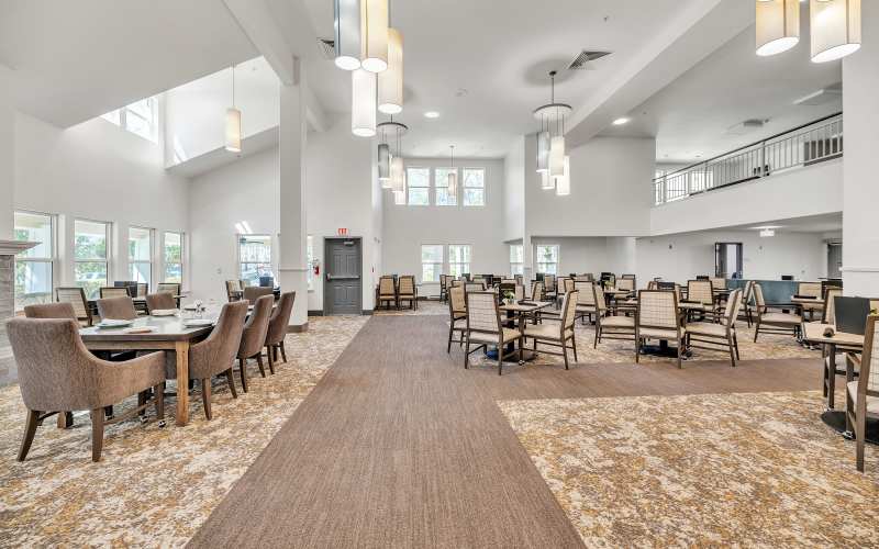 Bright dining room with chairs and tables arranged