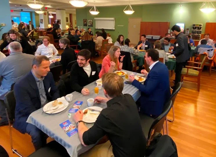 Residents and staff enjoying a meal together.