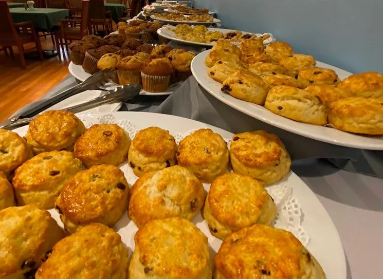 An assortment of freshly baked scones and muffins.