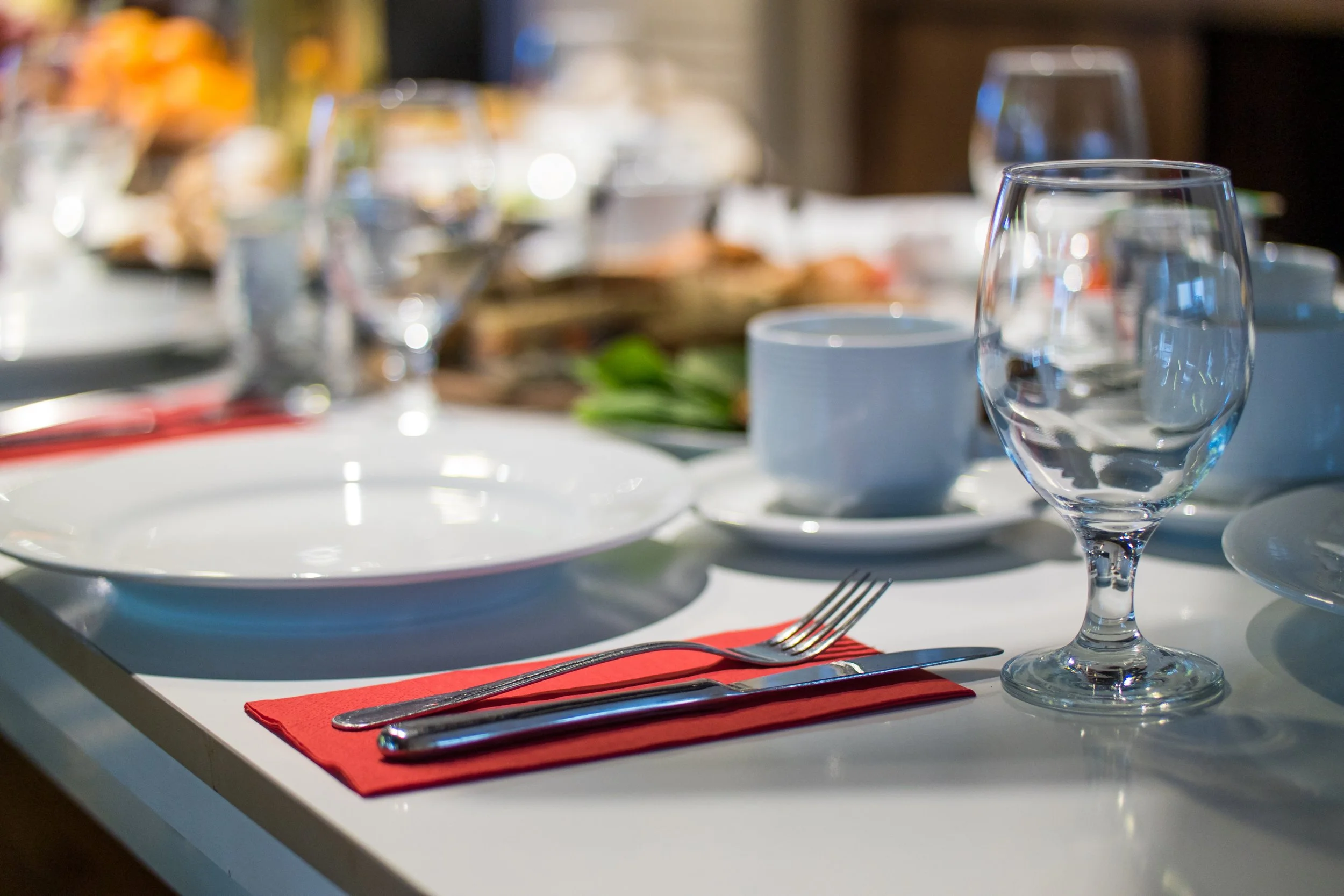 Set dining table with empty plates and glassware