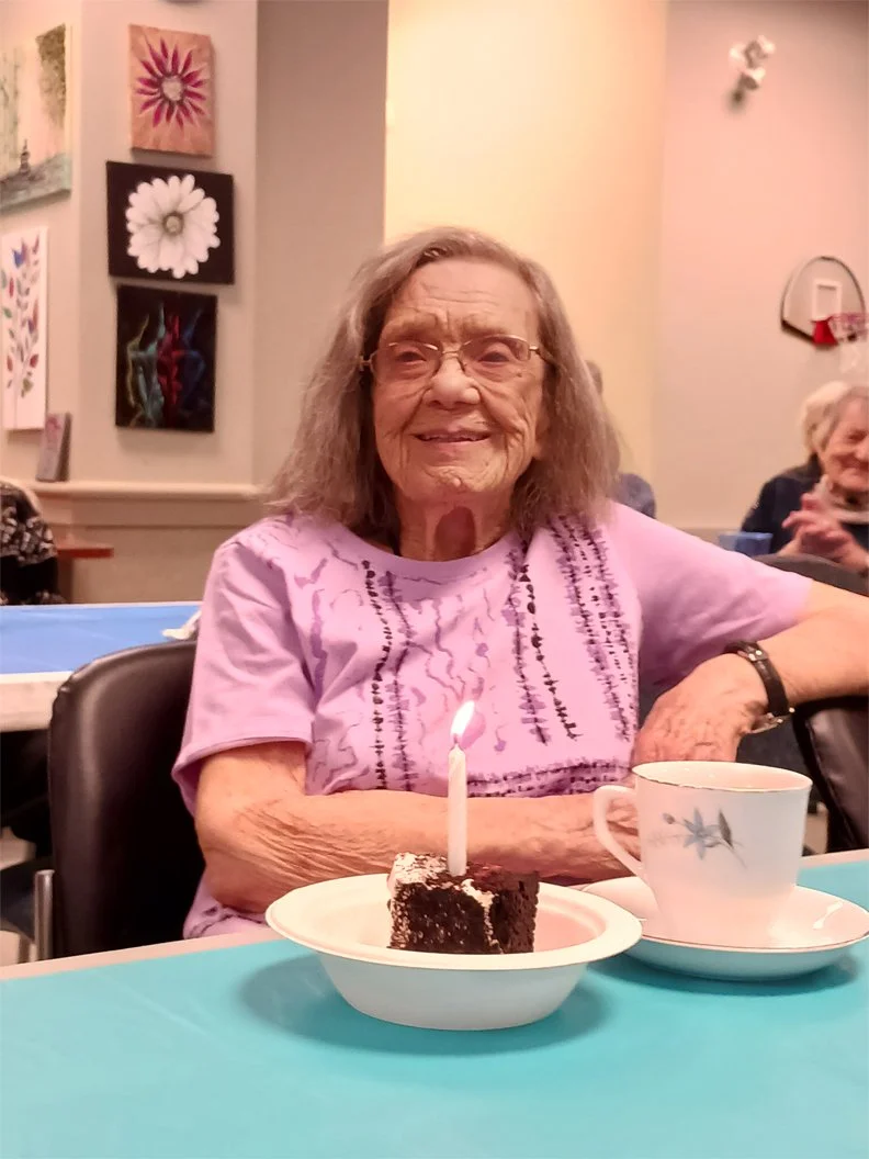 Resident celebrating with cake and coffee.