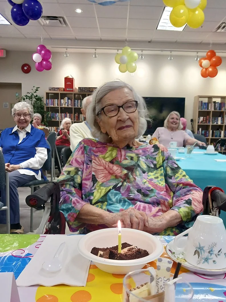 Resident celebrating with cake during an activity
