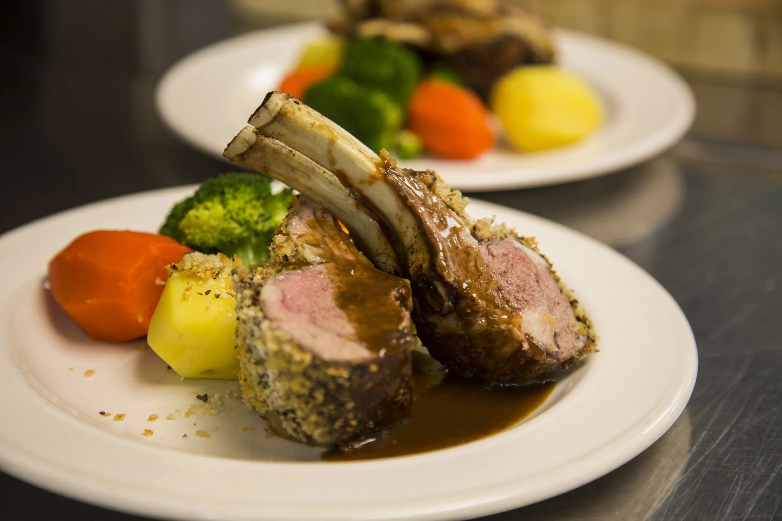 Gourmet lamb dish with vegetables on a plate