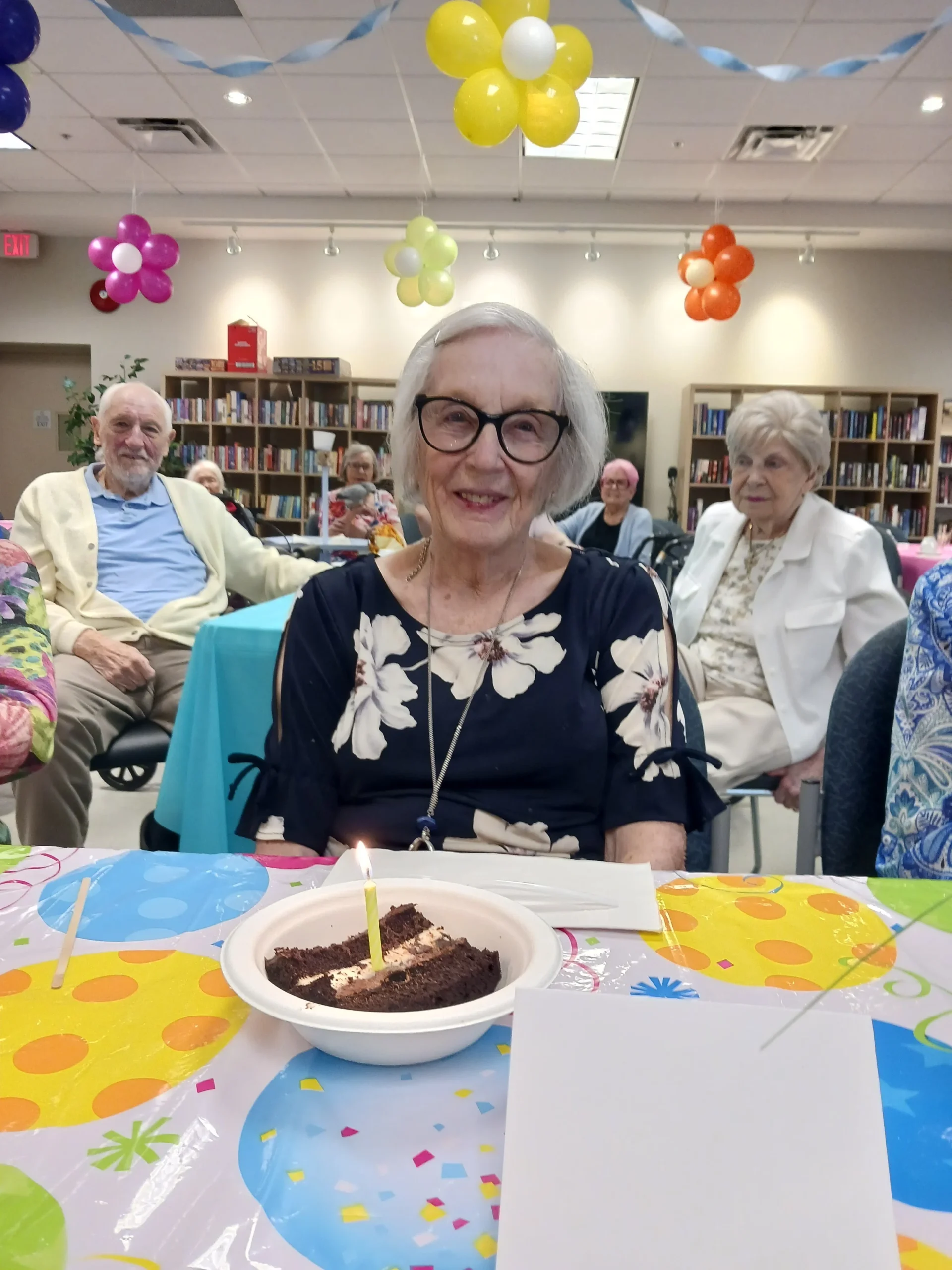 Resident celebrating with cake at a community event.