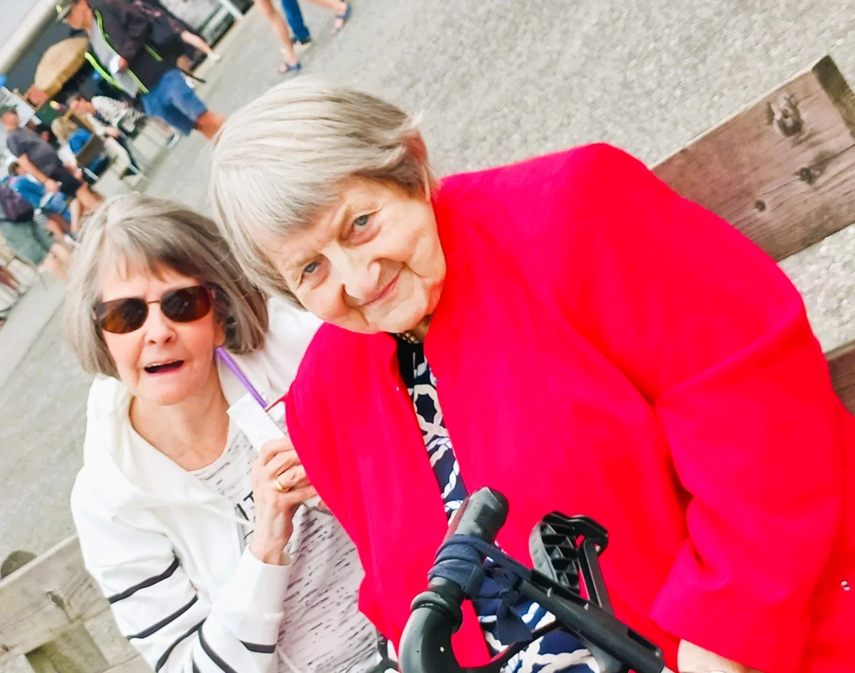 Two elderly women sitting together outdoors