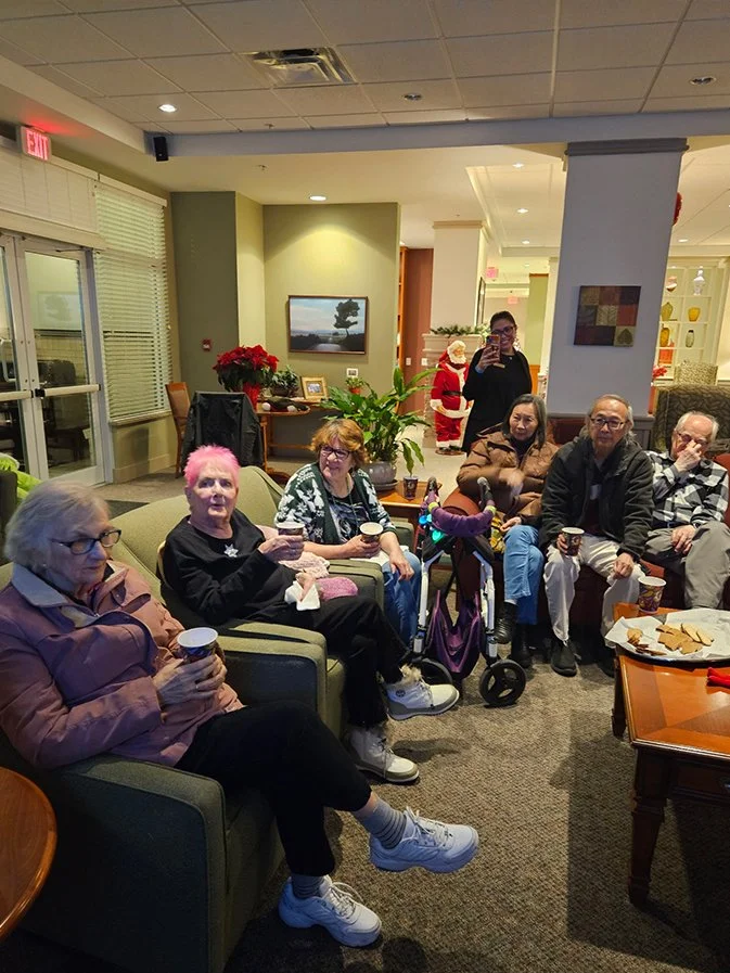 Residents enjoying coffee and snacks in a cozy common area.