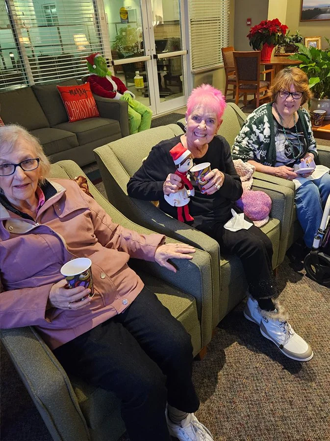 Residents enjoying a festive gathering in the common area.