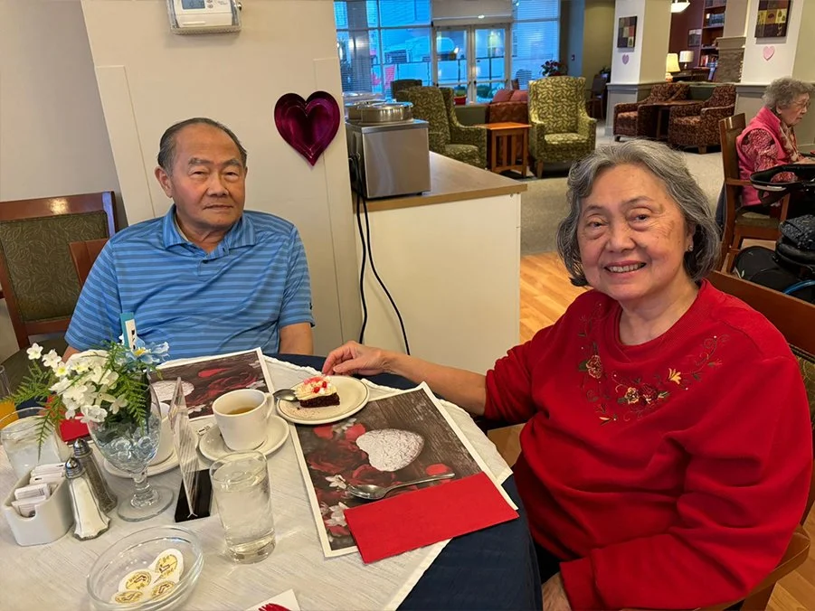 Two residents enjoying dessert in the dining area.