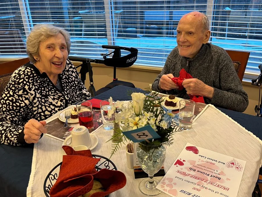 Residents enjoying dessert and conversation at a table