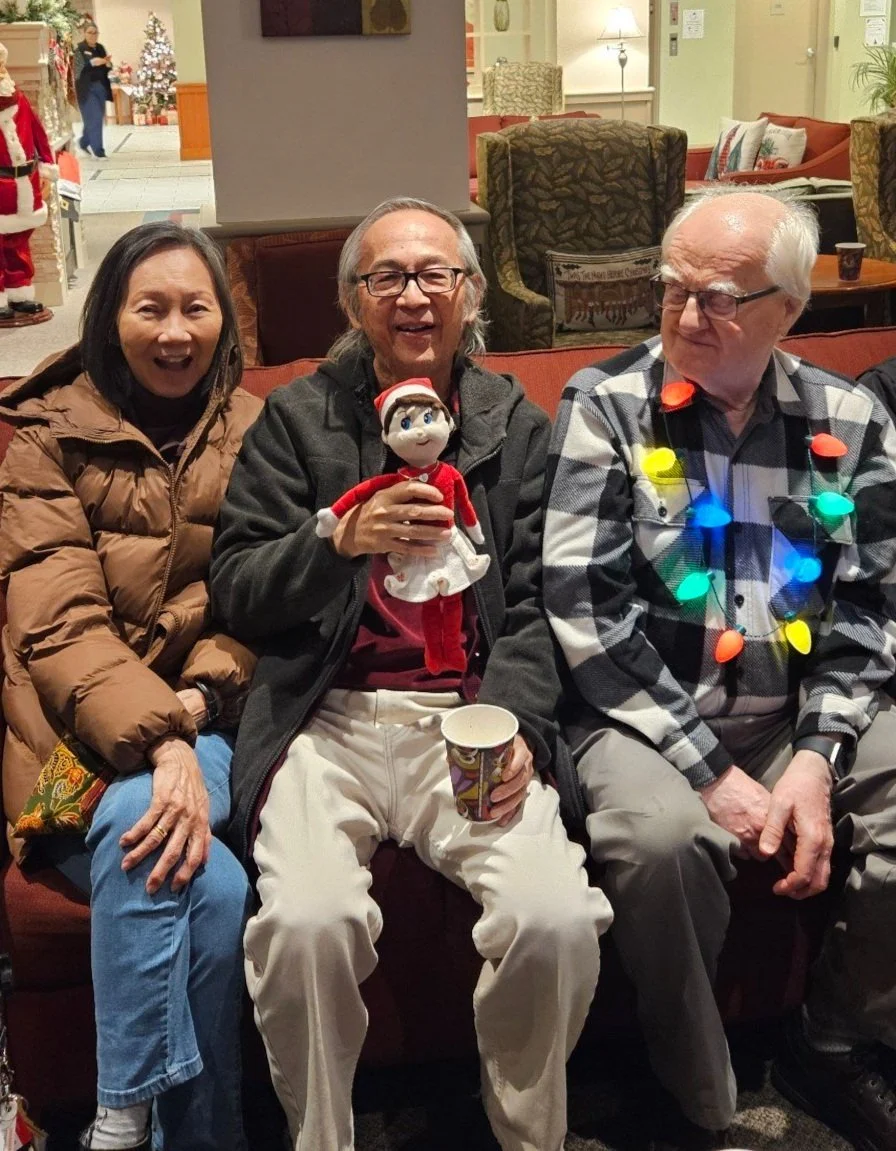 Residents celebrating with holiday decorations and smiles.