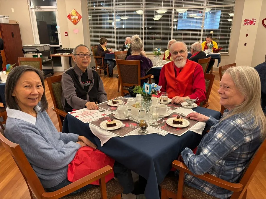 Residents enjoying dessert in the dining room.
