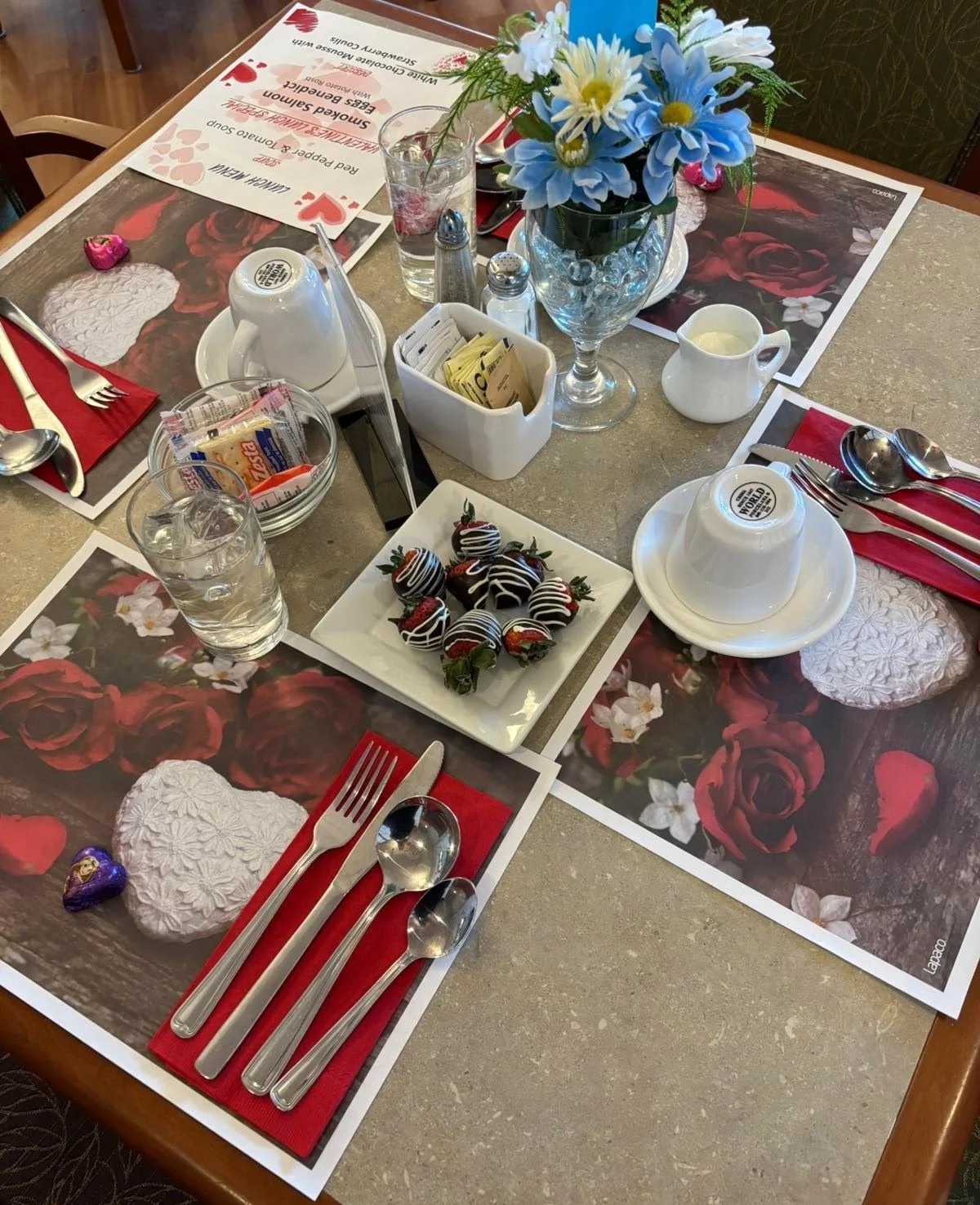 A dining setup with dessert and drinks.