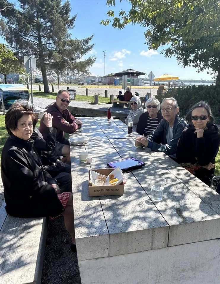 Residents socializing outdoors at a table