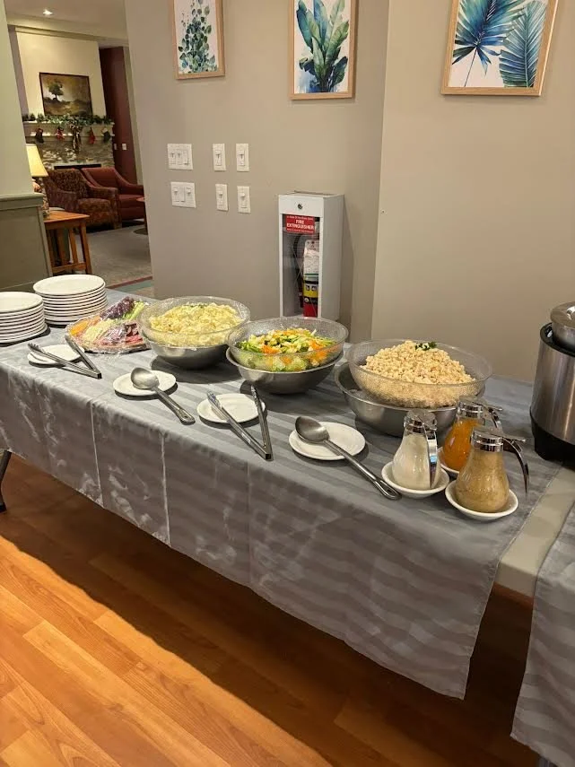 A dining table set with various food options.