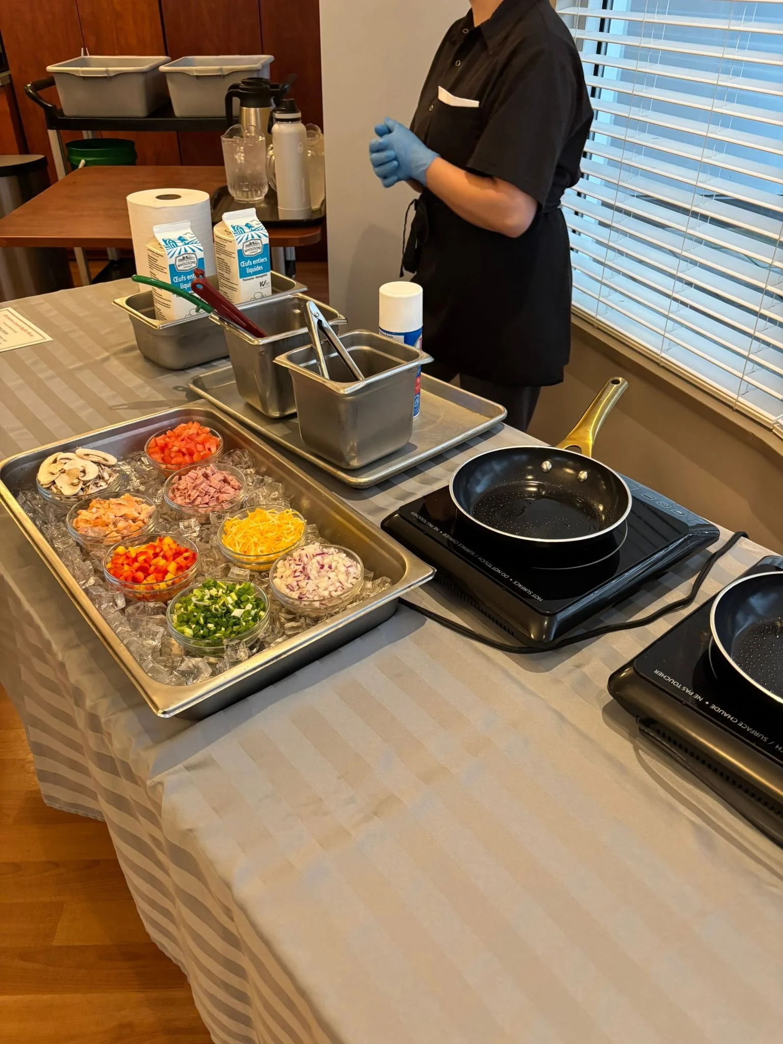 Staff member preparing a meal with fresh ingredients