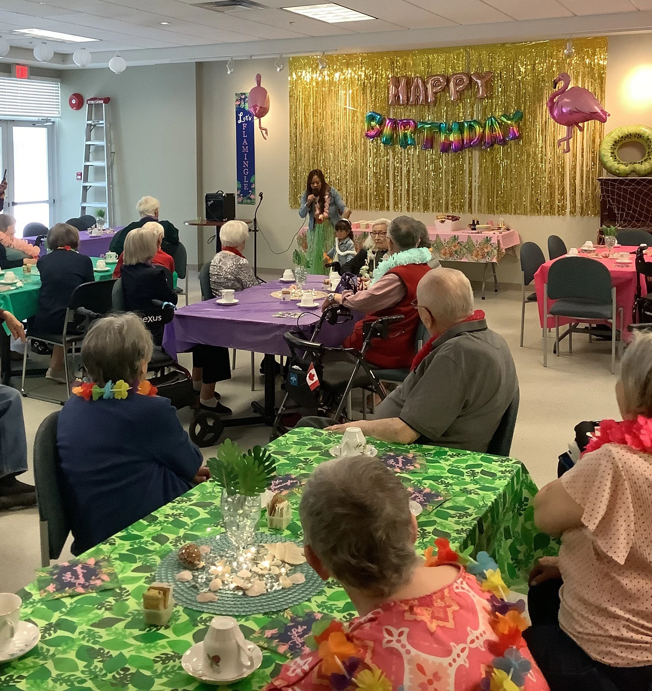 Residents celebrating a birthday with decorations and activities.
