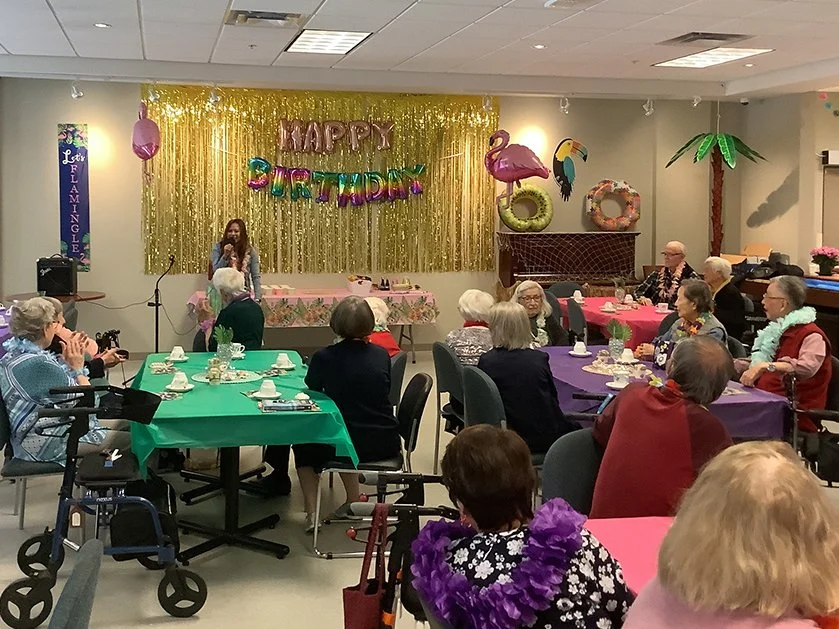 A birthday celebration with residents and decorations.