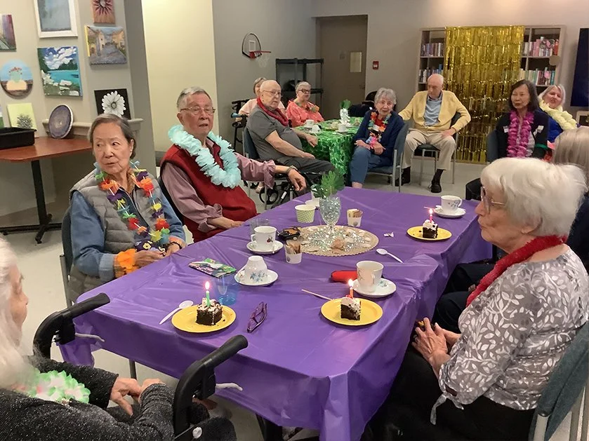 Residents celebrating with decorations and cake.