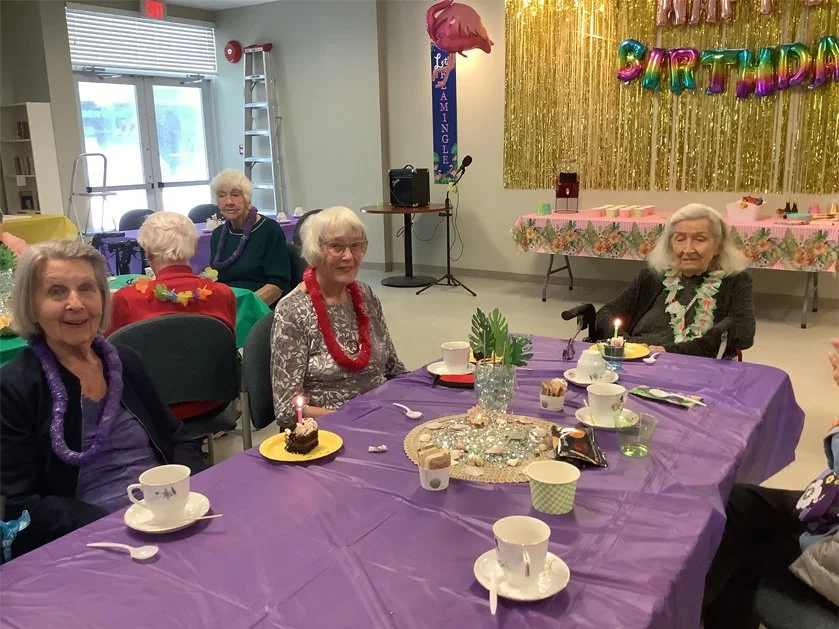 Residents celebrating a birthday party with decorations.