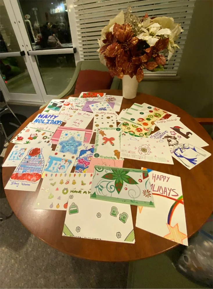 Colorful holiday-themed art displayed on a table.