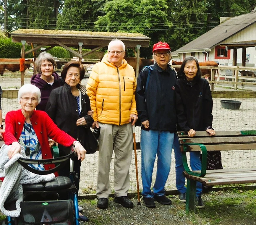 Residents enjoying outdoor space with a caregiver