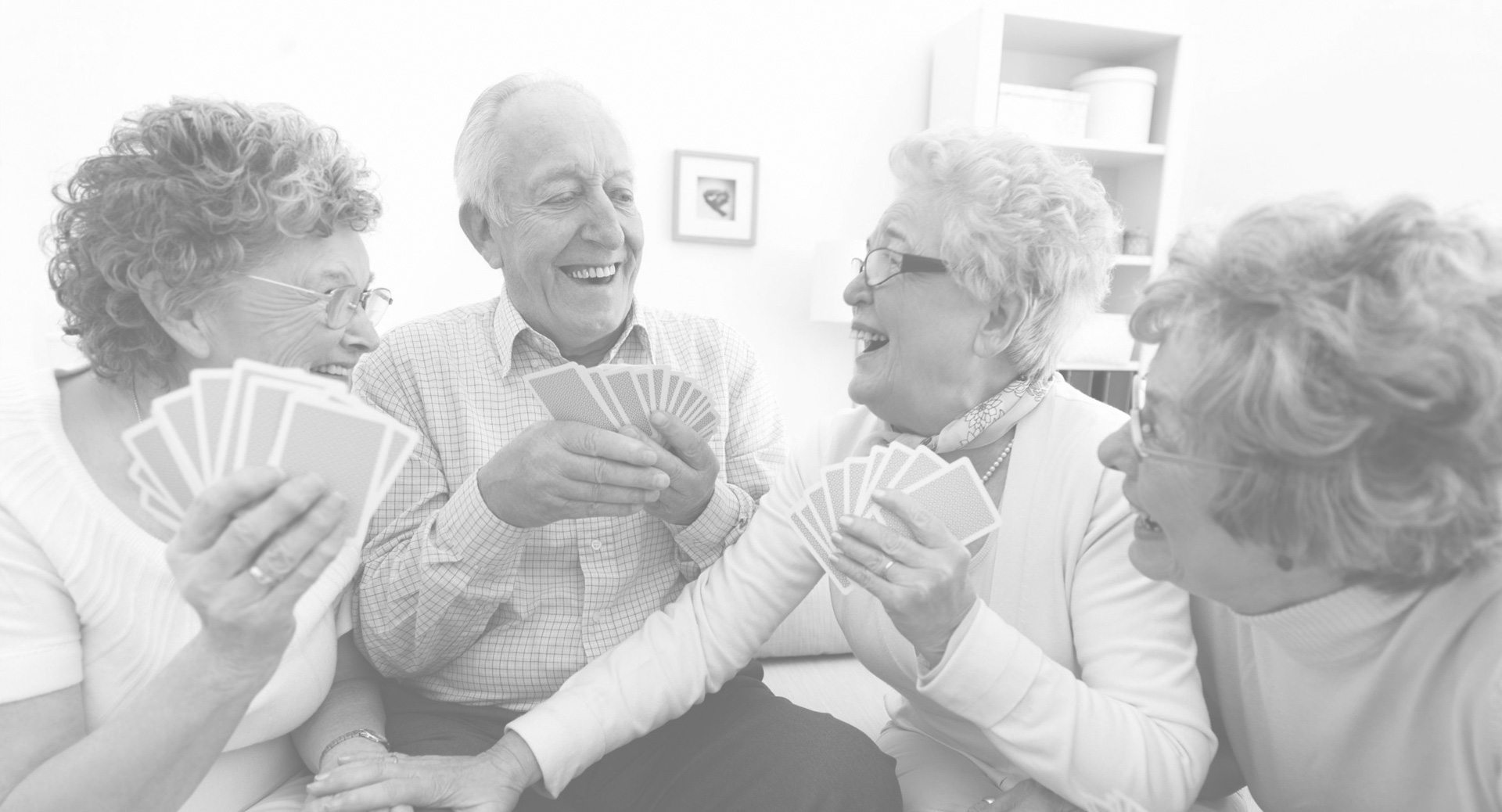 Seniors enjoying a card game in a common area