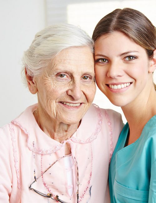 Senior resident smiling with a caregiver