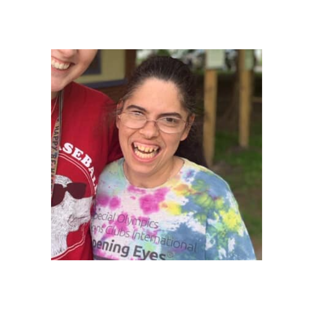 A resident smiling at an outdoor event.