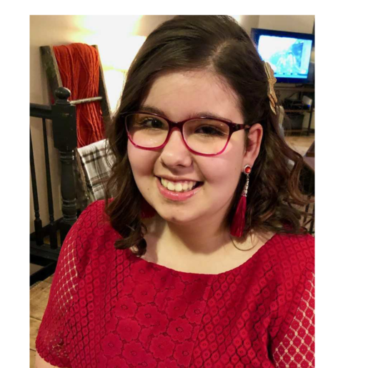 Young woman smiling in a red dress.