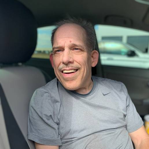 Smiling man sitting in a car.