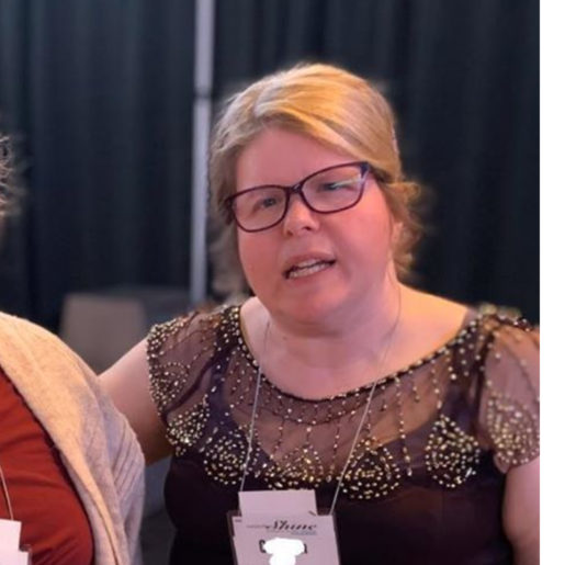 Two women talking at an event.