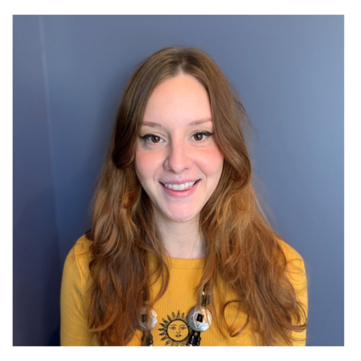 Smiling young woman with long hair in a yellow sweater