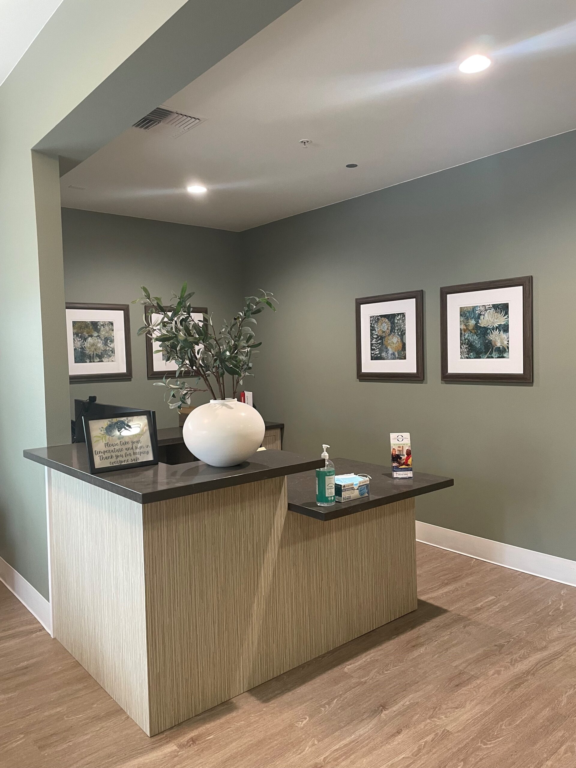 Reception area with decorative plants and artwork
