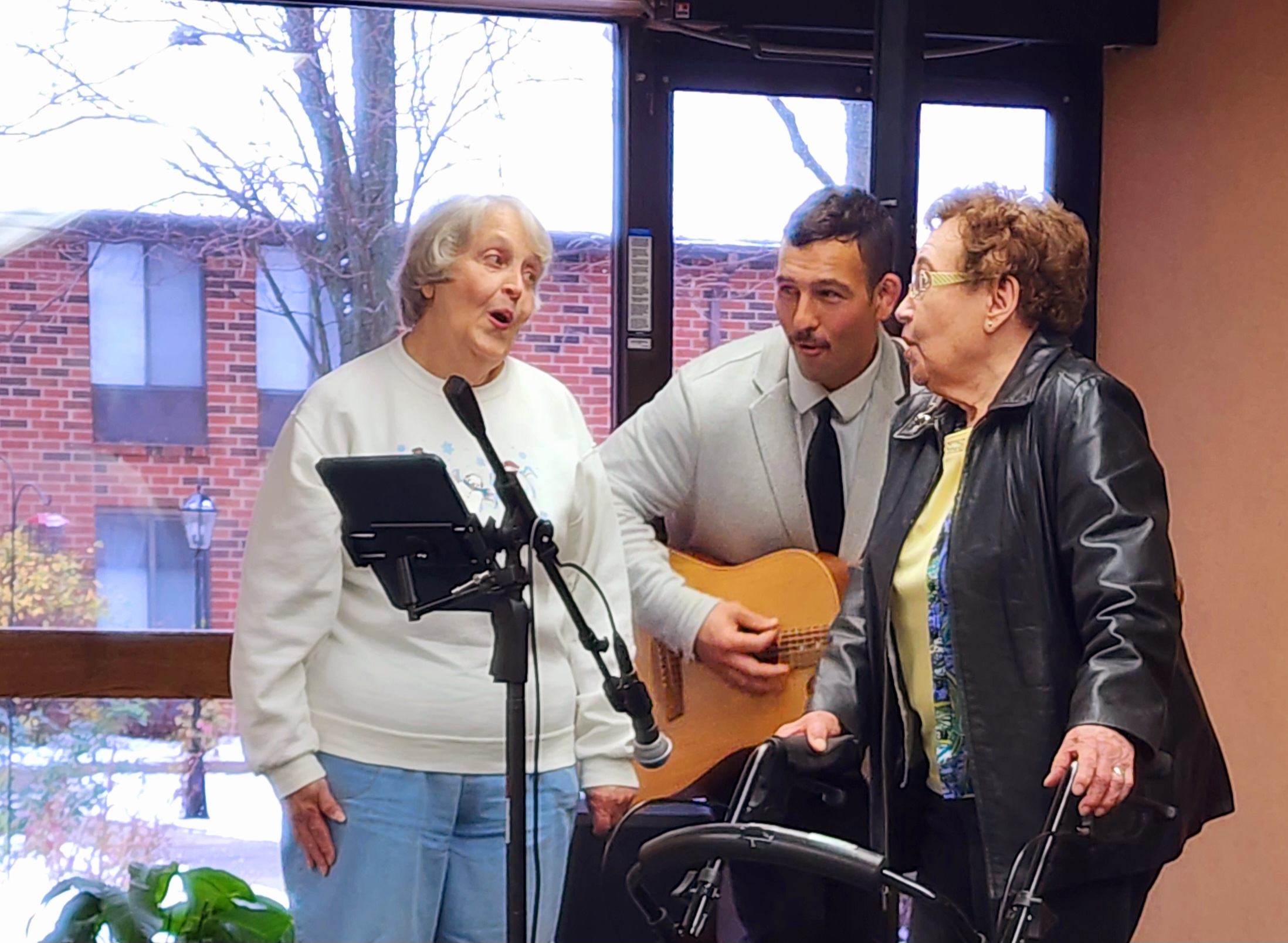 Residents enjoying a musical performance in a common area