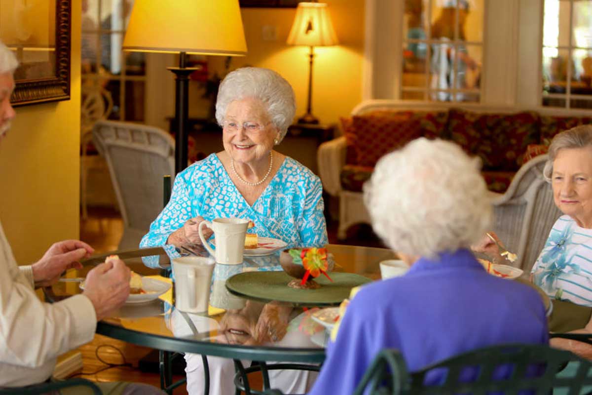 Residents enjoying snacks and conversation in a common area